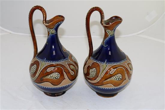 A pair of Doulton Lambeth Art Nouveau stoneware ewers, by Frank A Butler, c.1900, height 24cm (9.5in.)